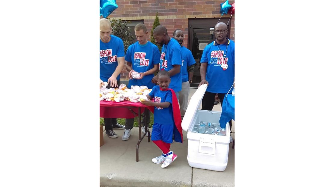 Austin Perine travels to Detroit to feed the homeless in his superhero red cape. 