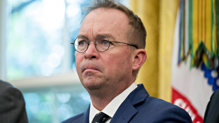 Mick Mulvaney, director of the Office of Management and Budget (OMB), listens during a meeting with U.S. President Donald Trump, not pictured, and workers in the Oval Office of the White House during a "Cutting the Red Tape, Unleashing Economic Freedom" event in Washington, D.C, U.S., on Wednesday, Oct. 17, 2018. Trump plans to withdraw the U.S. from a treaty that gives Chinese companies discounted shipping rates for small packages sent to American consumers, another escalation of his economic confrontation of Beijing. Photographer: Andrew Harrer/Bloomberg via Getty Images