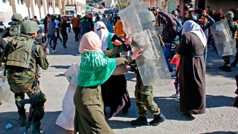Palestinian security forces clash with Hamas supporters in Hebron on Friday.