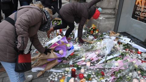 People lay flowers in tribute to the victims of Cherif Chekatt, on December 14, 2018 at Strasbourg's Christmas market, a day after French police shot him dead. 