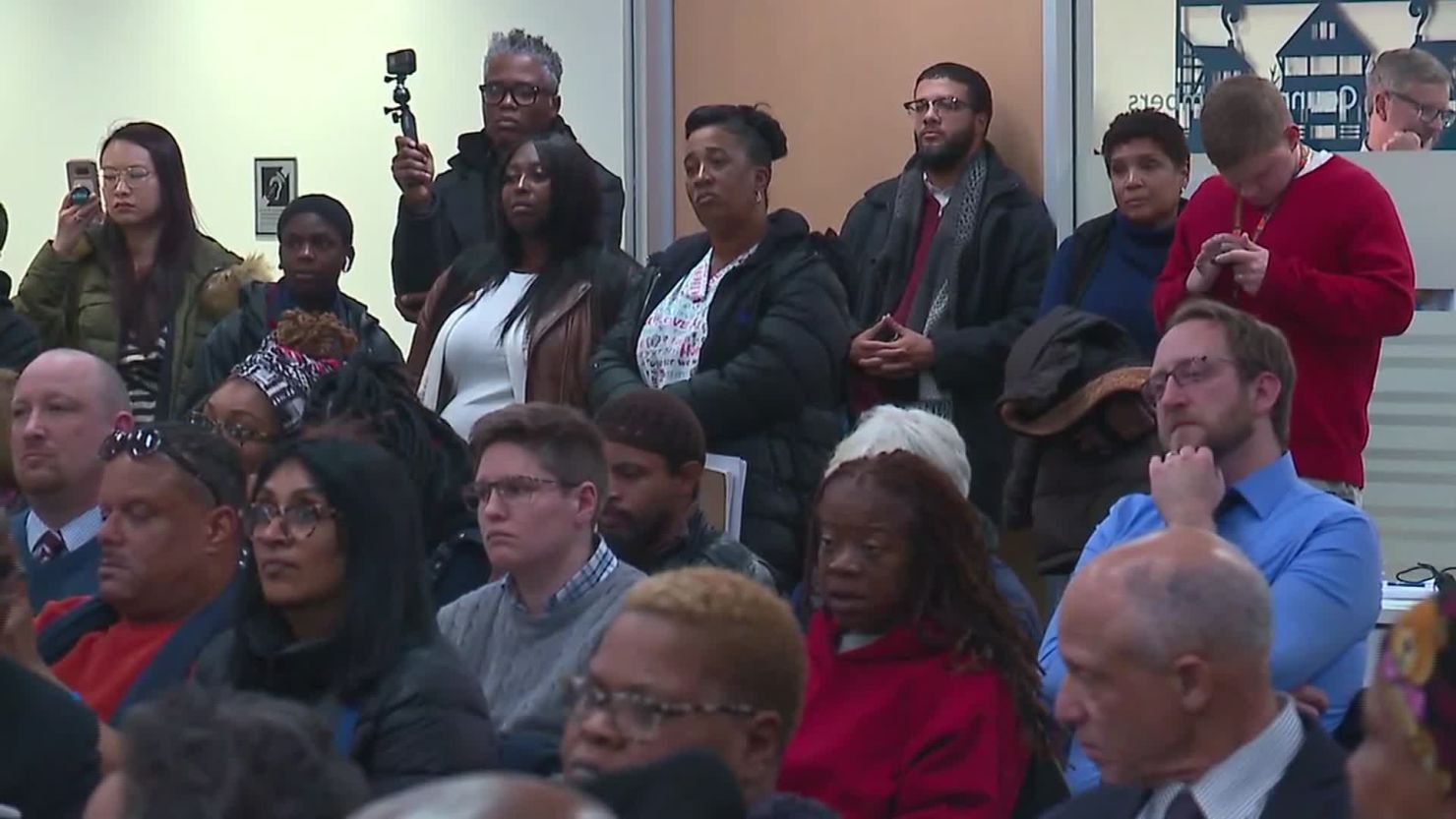 Jacqueline Jackson, standing at center in back, waits her turn to address the county council about conditions in local jails. Her nephew died in a Cuyahoga County correctional facility in 2015.