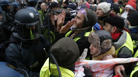 "Yellow vest" demonstrators face riot police officers Saturday in the French capital.