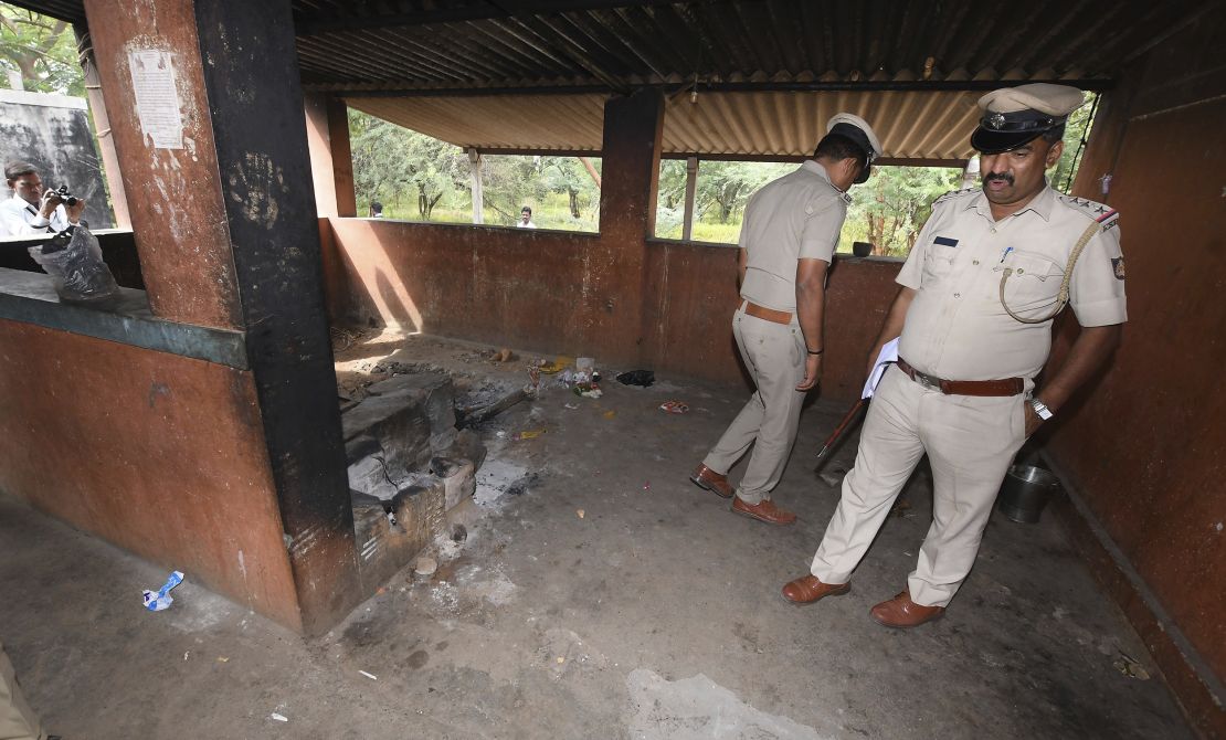 Indian policeman inspect the kitchen of a temple on Saturday after the incident.