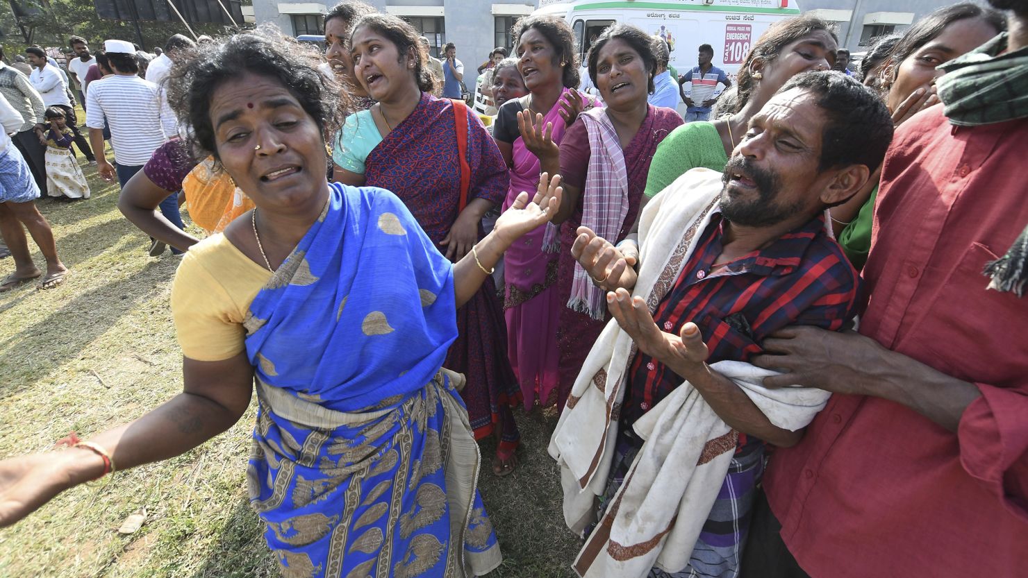 Indians mourn the death of relatives on Saturday in a case of suspected food poisoning in the Chamarajanagar district of Karnataka state, India.