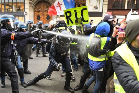 Police use tear gas on protesters at the Place de l'Opera in Paris on December 15.