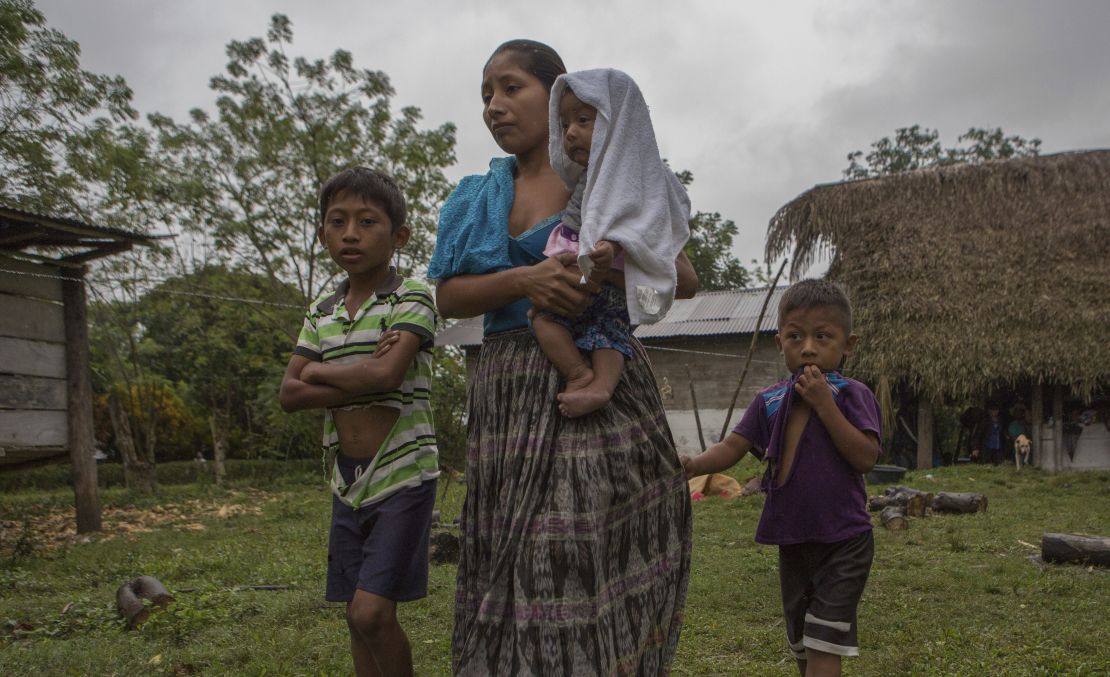 Claudia Maquin, 27, walks with her three surviving children in Raxruha, Guatemala, Saturday.