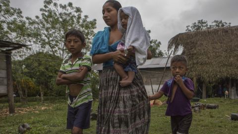 Claudia Maquin, 27, walks with her three surviving children in Raxruha, Guatemala, Saturday.