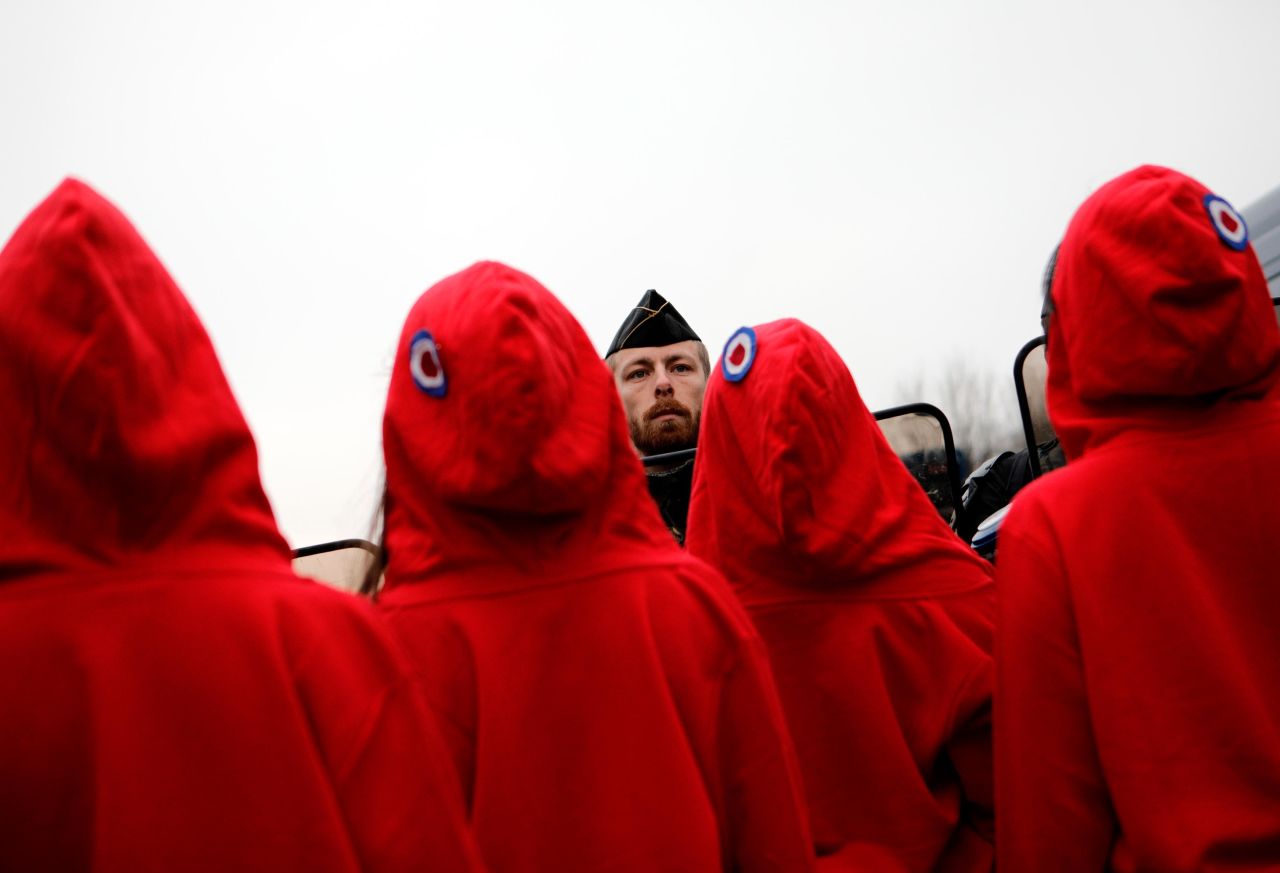 Activists dressed like Marianne, the symbol of the French Republic, face riot police on December 15 in Paris.