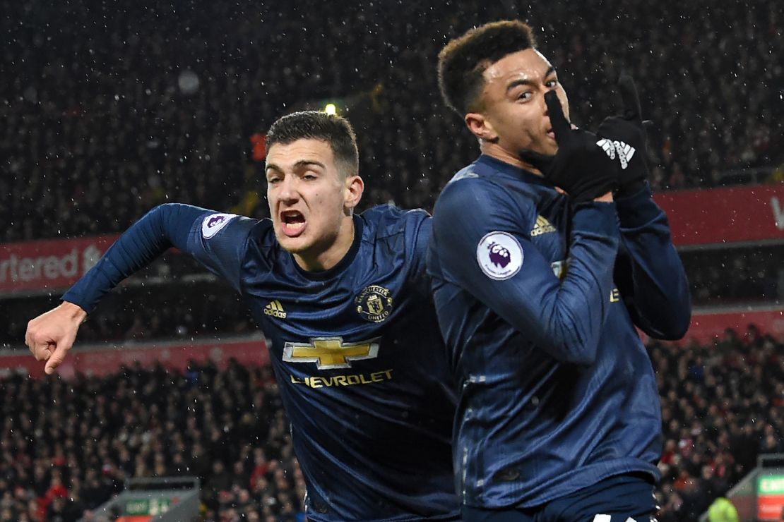 Jesse Lingard celebrates his equalizer for Manchester United at Anfield with Diogo Dalot (left).

