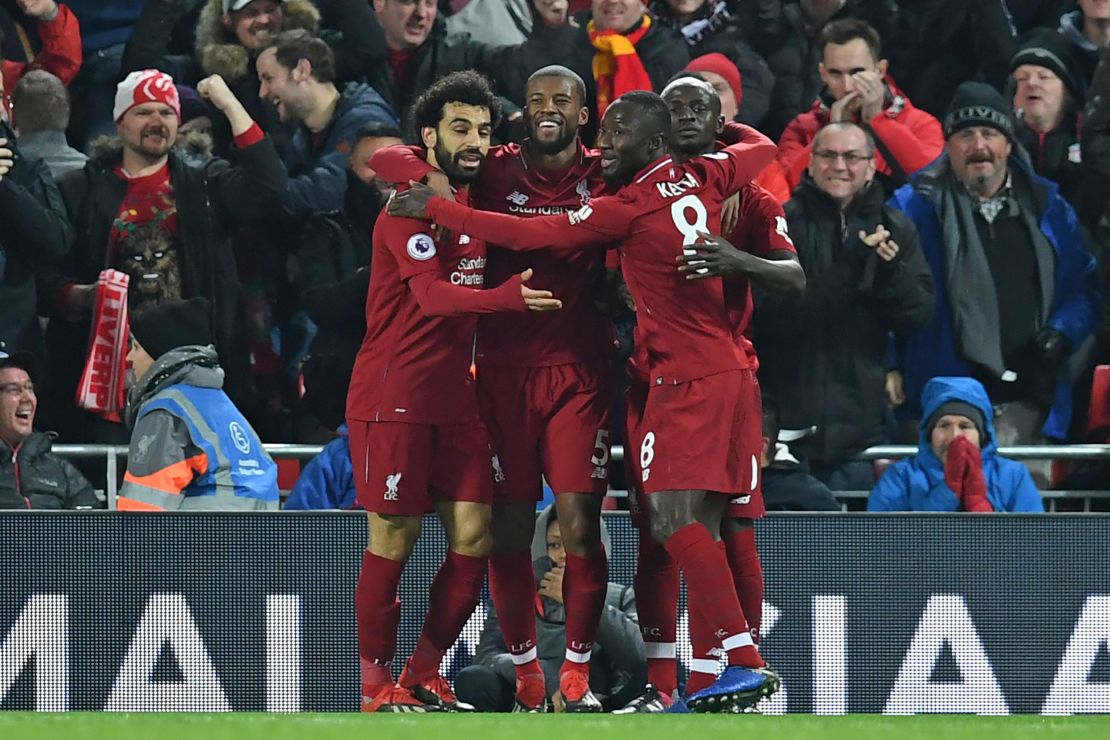 Liverpool's Senegalese striker Sadio Mane celebrates with his teammates after scoring the opener against Manchester United at Anfield. 