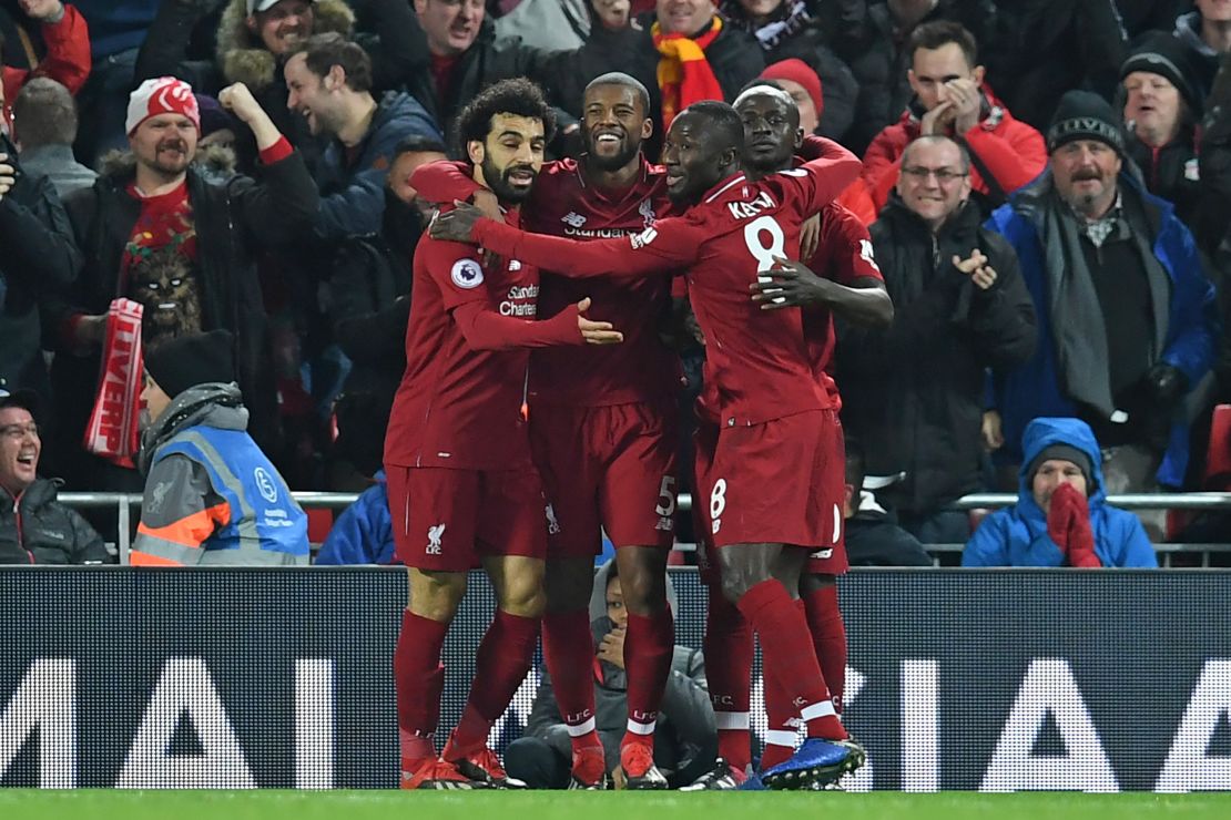 Liverpool's Senegalese striker Sadio Mane celebrates with his teammates after scoring the opener against Manchester United at Anfield.