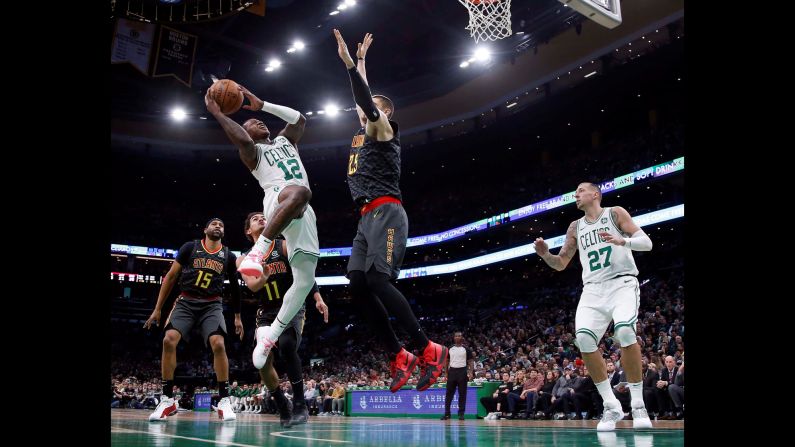 Boston Celtics guard Terry Rozier goes up for a shot against Atlanta Hawks center Alex Len during the second half of an NBA game at TD Garden on December 14 in Boston, Massachusetts. Boston won the game 129-108.