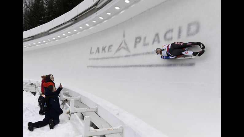 Raychel Michele Germaine of the United States passes by fans during her qualifying run in the Nations Cup Viessmann World Cup luge competition on December 14 in Lake Placid, New York.