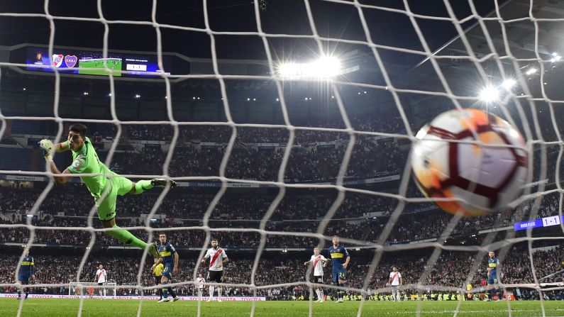 Boca Juniors' goalkeeper Esteban Andrada watches the ball hit the back of the net during a match between River Plate and Boca Juniors at the Santiago Bernabeu Stadium in Madrid, Spain on December 9. River Plate won the match 3-1.