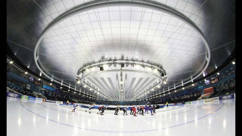 Competitors skate around the Thialf ice arena during the starting event for the women's semifinal World Cup speed skating competition in Heerenveen, Netherlands on Friday, December 14.