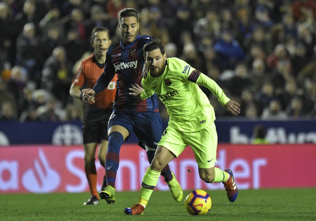 Levante midfielder Ruben Rochina (left) vies with Messi at the Ciutat de Valencia stadium. 