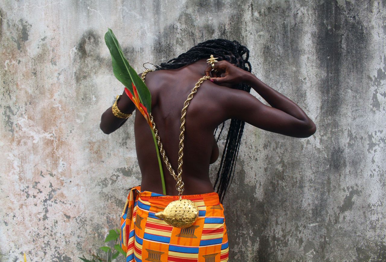 <a href="https://www.instagram.com/ngadismart/" target="_blank" target="_blank">Ngadi Smart</a> is a Sierra Leonean Photographer based in Côte d'Ivoire, whose focus is on documenting cultures, subcultures and intimacy. Her photographic work has long been focused on how people self-identify and choose to present themselves in front of the lens. As of late, her interest has been documenting Black sensuality through an African lens and point of view. She aims to show as many representations of African people, and what it means to be African, as she can. In this photo, she shows <a href="https://www.instagram.com/madohamboue/" target="_blank" target="_blank">Mado </a>with Akan male symbols for her series titled "Amorphophallus aphyllus", (named after the phallic hermaphrodite African plant). This is a series on African Masculinity and Femininity, their various interchangeable facets and the intricate "masks" and layers we hold on to.