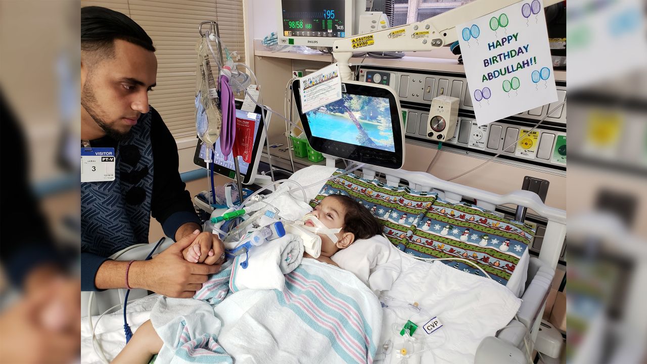 Ali Hassan sits by Abdullah's bedside at an Oakland hospital.