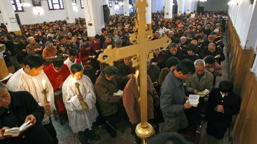 Chongqing, CHINA: Local worshippers pray during a mass to celebrate Good Friday ahead of Easter Sunday at St. Joseph's Church in China's southwestern municipality of Chongqing, 06 April 2007. Chinese Christians are preparing to celebrate Easter amid a nationwide religious renaissance led by an army of young people seeking faith in the modern world, religious leaders and academics said.   AFP PHOTO/LIU Jin (Photo credit should read LIU JIN/AFP/Getty Images)