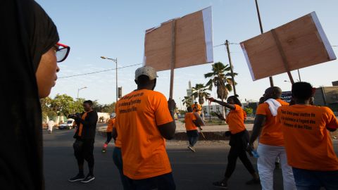 Demonstrators march to end violence against women in central Dakar on Sunday, December 9.