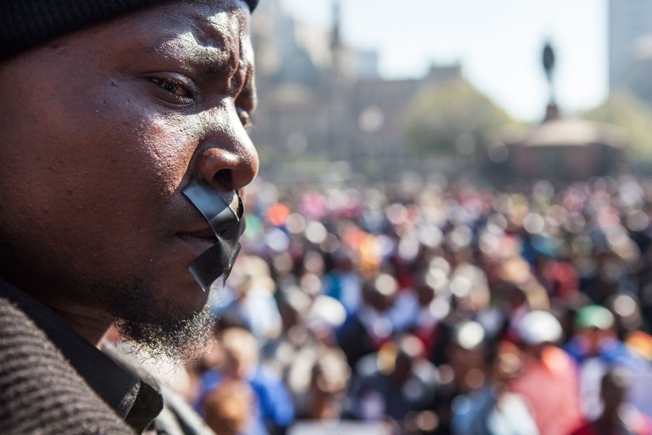 A man is seen with tape over his mouth during a "Not In My Name" march organized on May 20, 2017 in Pretoria against the abuse of women following the spike in reports of women being murdered and raped in various parts of the country. 