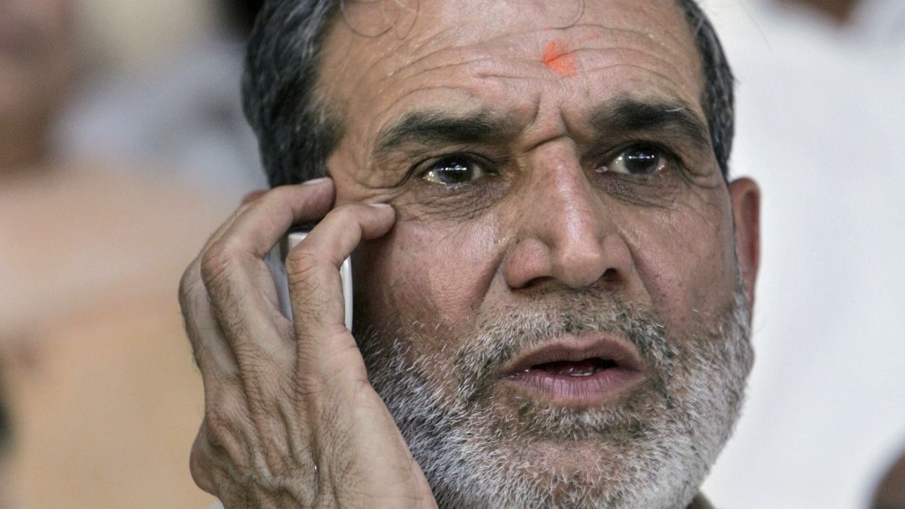 In this August 2005 file photo, Sajjan Kumar talks on a mobile phone at an event in New Delhi. An Indian court has sentenced Kumar for his role in inciting violence during anti-Sikh pogroms in 1984.