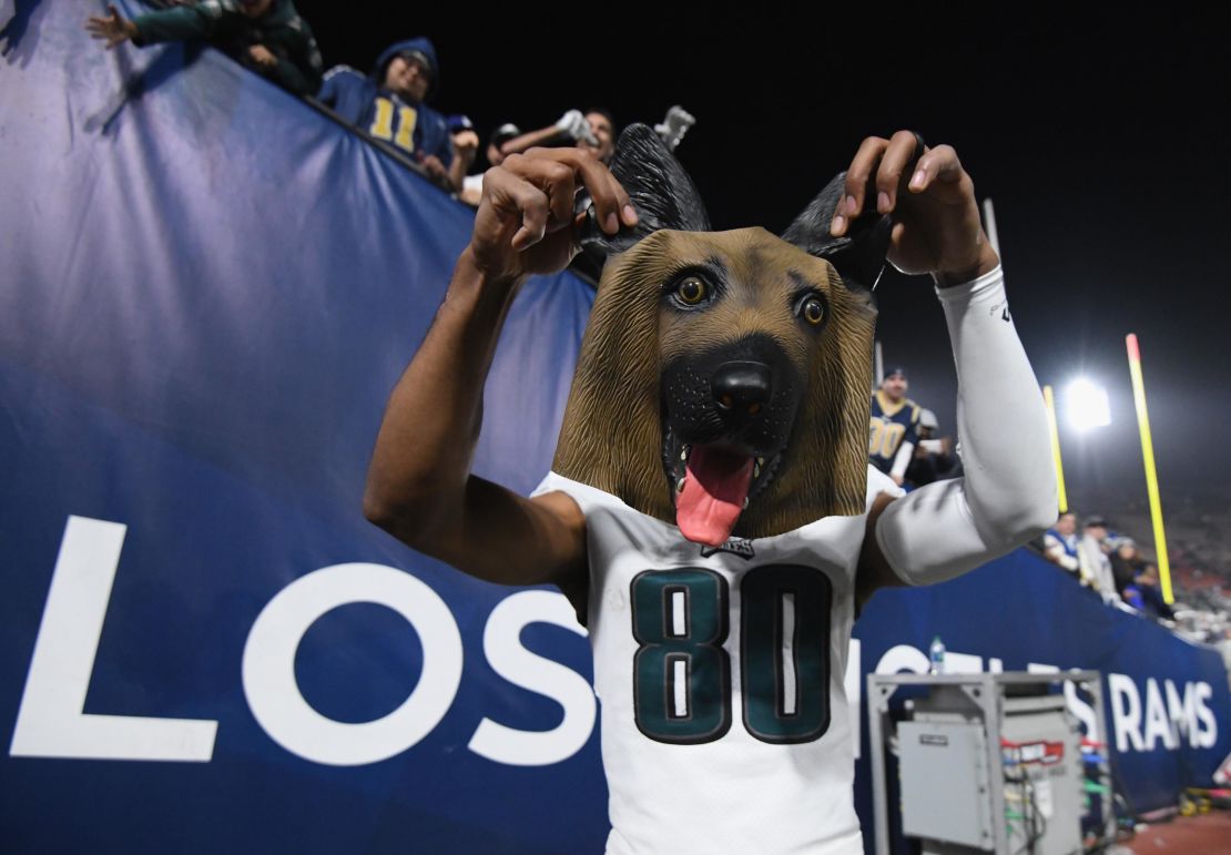 Jordan Matthews of the Philadelphia Eagles holds up a dog mask received from a fan after the team's big 30-23 win over the Los Angeles Rams.