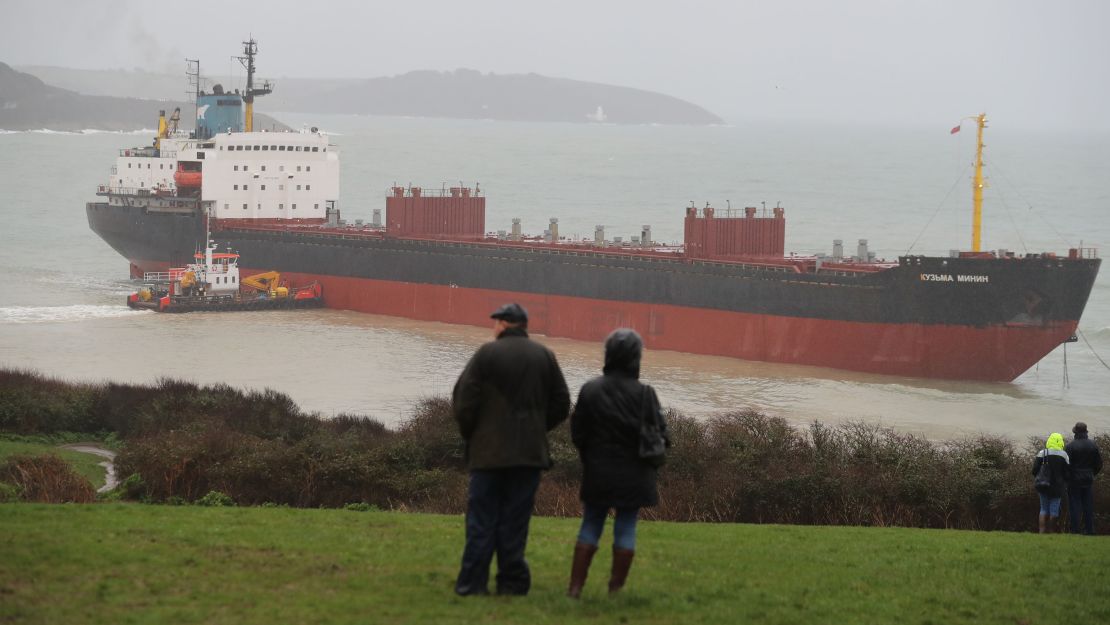 Local residents look out at the striken cargo ship on Tuesday afternoon. 