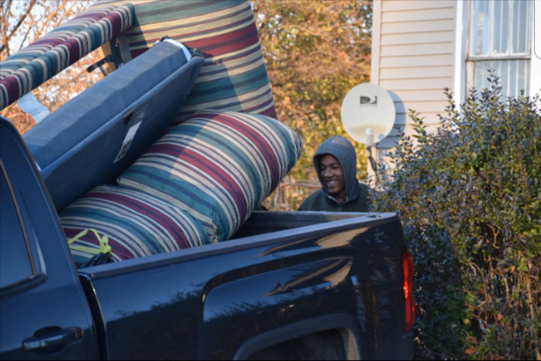 Volunteer Levi Lindsey loads furniture into Guido's pickup truck.