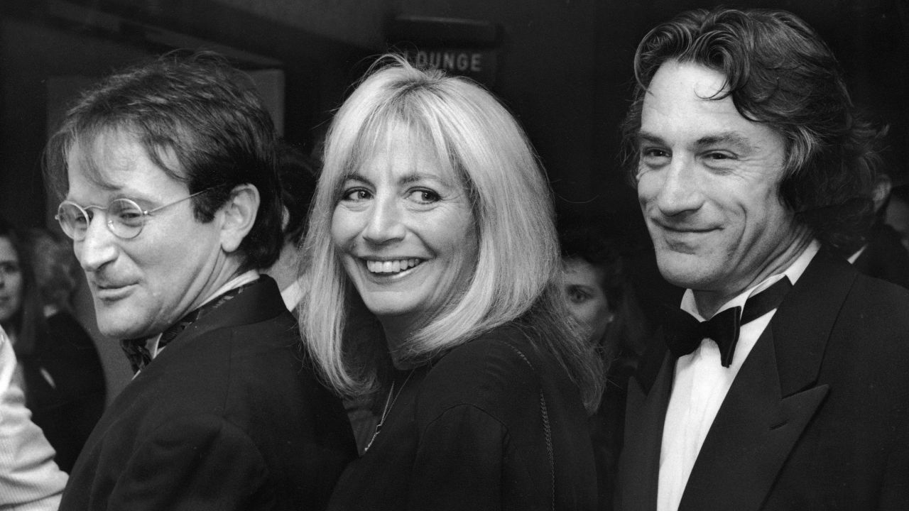 Williams is joined by actors Robin Williams, left, and Robert DeNiro at the premiere of their film "Awakenings" in 1990.