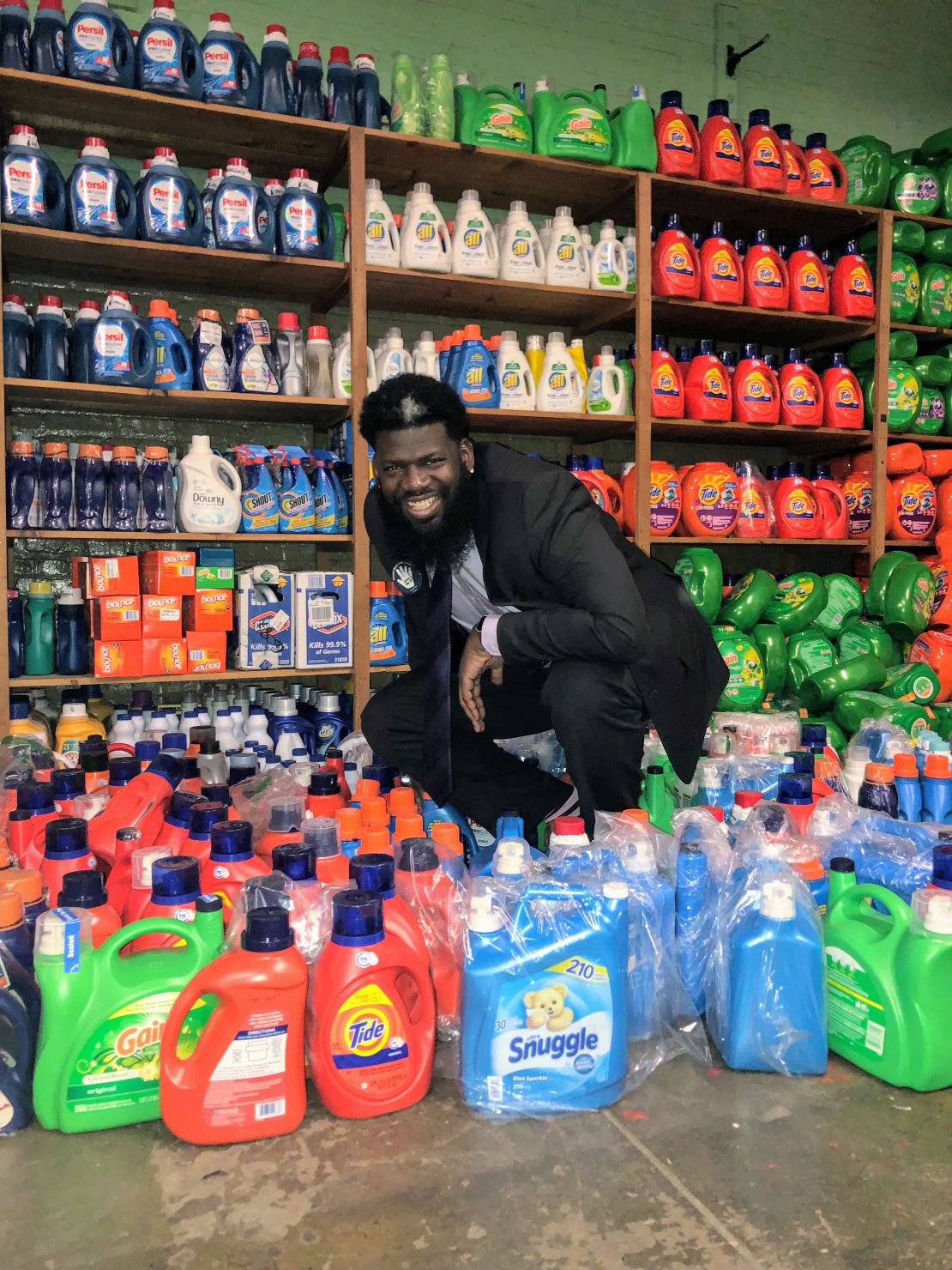 Principal Akbar Cook shows a portion of the donated detergent sent to New Jersey's West Side High School to support their free laundry room.