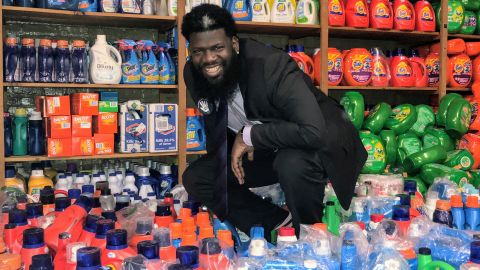 Principal Akbar Cook shows a portion of the donated detergent sent to New Jersey's West Side High School to support their free laundry room.