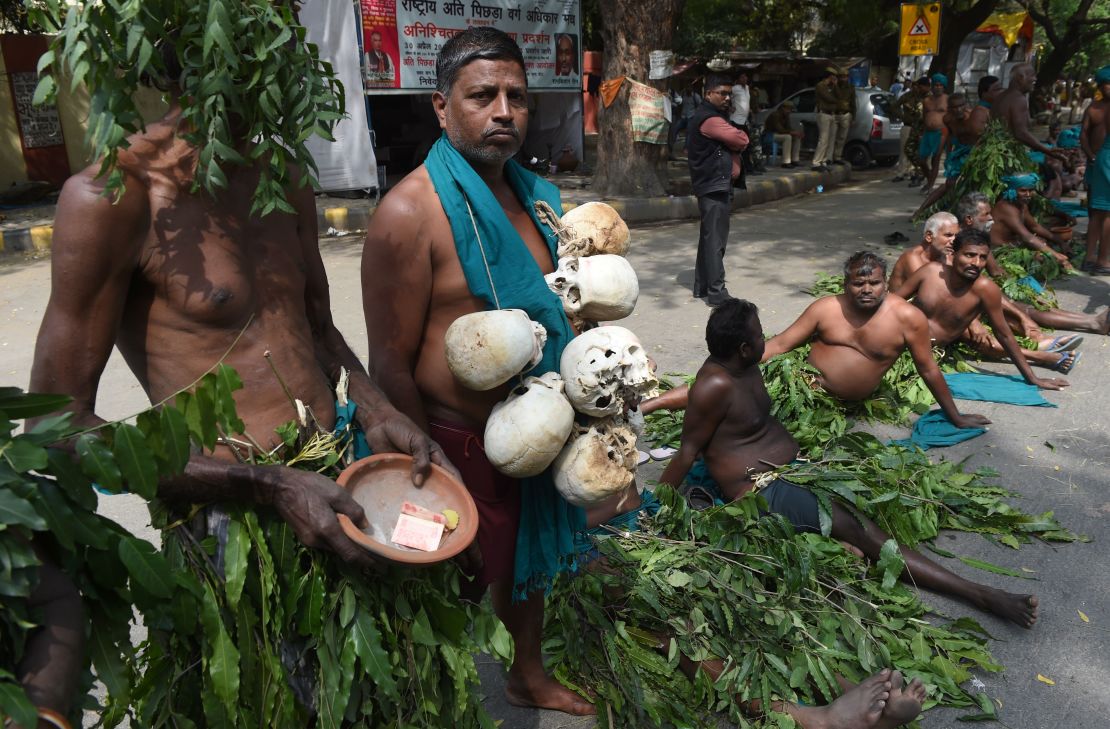 Indian farmers from the southern state of Tamil Nadu wear tree leaves and hold symbolic 'skulls' as they take part in a protest in New Delhi on March 16, 2017.
