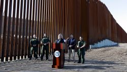 U.S. Department of Homeland Security Secretary Kirstjen Nielsen, center, speaks in front of a newly fortified border wall structure Friday, Oct. 26, 2018, in Calexico, Calif. (AP Photo/Gregory Bull)