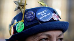 A badge reading "Brexit: Is it worth it?" is picture on the hoat of an anti-brexit activist as they protest outside the Houses of Parliament in central London on December 17, 2018, ahead of a statement by Britain's Prime Minister Theresa May in the House of Commons later today. - Prime Minister Theresa May will on Monday warn MPs against supporting a second Brexit referendum, as calls mount for a public vote to break the political impasse over the deal she struck with the EU. "Let us not break faith with the British people by trying to stage another referendum," she will tell parliament, according to extracts from her speech released by Downing Street. (Photo by Tolga AKMEN / AFP)        (Photo credit should read TOLGA AKMEN/AFP/Getty Images)