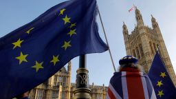 Anti-brexit campaigners wave flags outside the Houses of Parliament in central London on December 17, 2018.