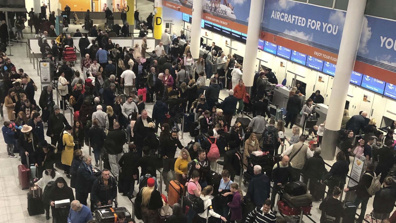Lines of passengers wait at the check-in desks at Gatwick Airport.