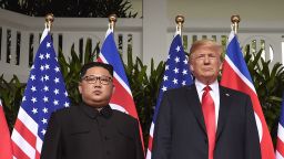 TOPSHOT - US President Donald Trump (R) poses with North Korea's leader Kim Jong Un (L) at the start of their historic US-North Korea summit, at the Capella Hotel on Sentosa island in Singapore on June 12, 2018. - Donald Trump and Kim Jong Un have become on June 12 the first sitting US and North Korean leaders to meet, shake hands and negotiate to end a decades-old nuclear stand-off. (Photo by SAUL LOEB / AFP)        (Photo credit should read SAUL LOEB/AFP/Getty Images)