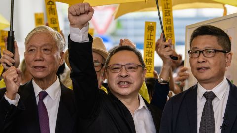 Baptist minister Chu Yiu-ming, 74, law professor Benny Tai, 54, and sociology professor Chan Kin-man, 59, shout slogans with supporters before entering the West Kowloon Magistrates Court in Hong Kong on November 19, 2018.