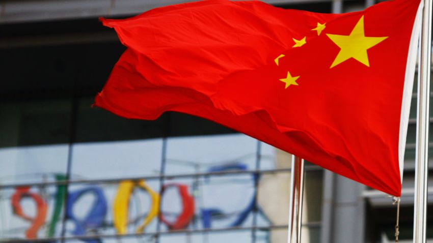 The Google logo is reflected in windows of the company's China head office as the Chinese national flag flies in the wind in Beijing on March 23, 2010 after the US web giant said it would no longer filter results and was redirecting mainland Chinese users to an uncensored site in Hong Kong -- effectively closing down the mainland site. Google's decision to effectively shut down its Chinese-language search engine is likely to stunt the development of the Internet in China and isolate local web users, analysts say.  AFP PHOTO/LI XIN (Photo credit should read li xin/AFP/Getty Images)