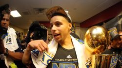 Stephen Curry of the Golden State Warriors celebrates with the Larry O'Brien NBA Championship Trophy after he and the Golden State Warriors defeated the Cleveland Cavaliers in Game Six of the 2015 NBA Finals.