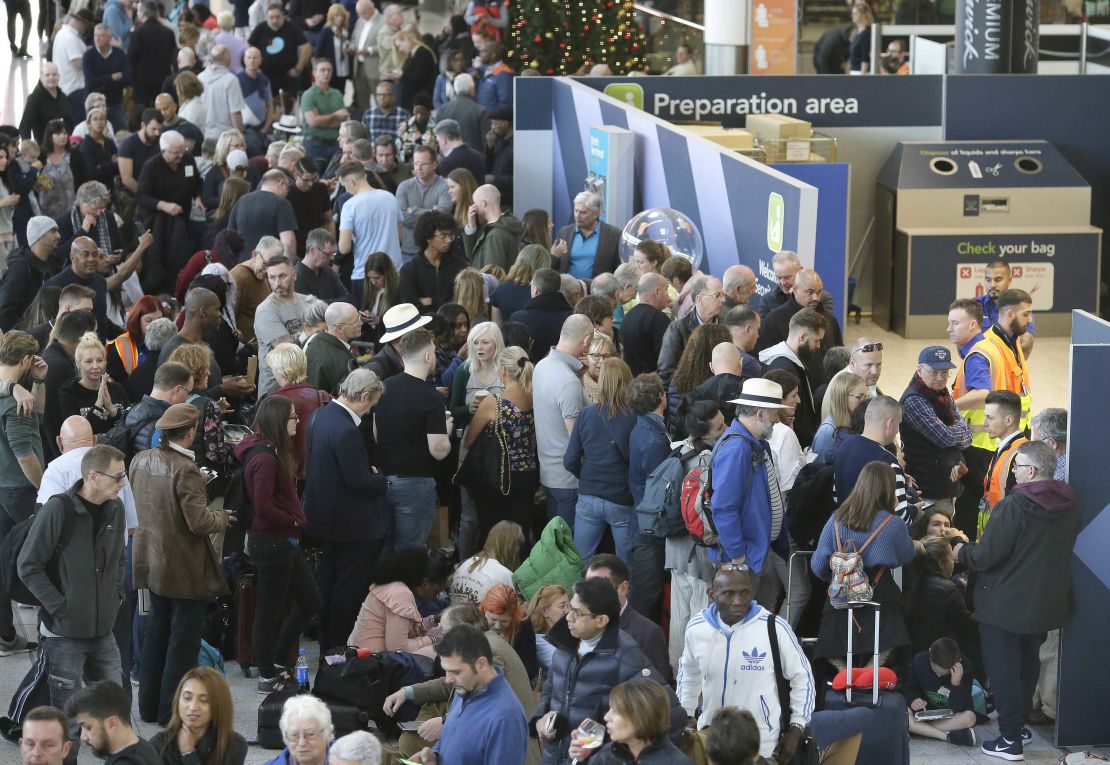 People wait near the departures gate at Gatwick airport on Thursday.