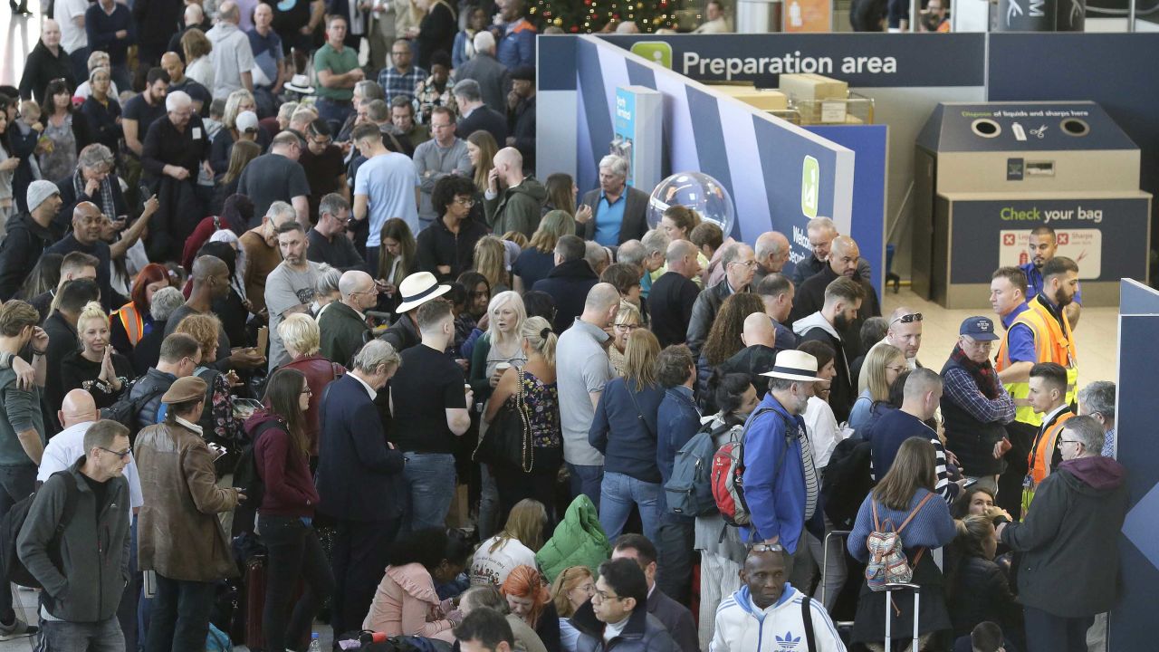 People wait near the departures gate at Gatwick airport on Thursday.