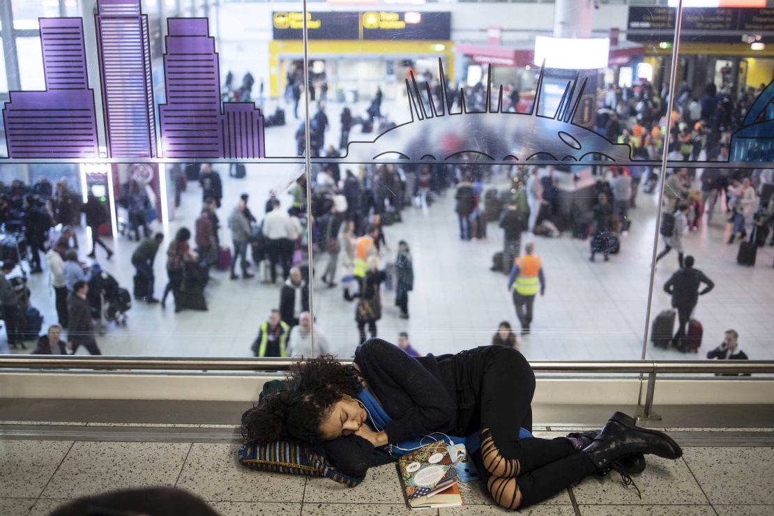 Stranded passengers sleeping on the floor.