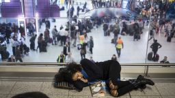 LONDON, ENGLAND - DECEMBER 20: A passenger sleeps on the floor of the departures lounge at Gatwick South Terminal on December 20, 2018 in London, England. Authorities at Gatwick closed the runaway after Drones were spotted over the airport on the night of December 19. The shutdown has sparked a succession of delays and diversions in the run up to the Christmas getaway, in what authorities have called a 'deliberate act' to disrupt the airport. (Photo by Dan Kitwood/Getty Images)
