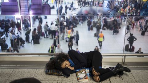 Stranded passengers sleeping on the floor.