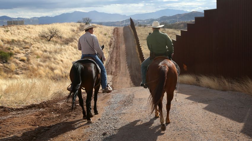 NOGALES, AZ - MARCH 08: U.S. Border Patrol ranch liaison John "Cody" Jackson (R) rides with cattle rancher Dan Bell on Bell's ZZ Cattle Ranch at the U.S.-Mexico border on March 8, 2013 in Nogales, Arizona. Jackson meets regularly with local ranchers to coordinate the agency's efforts on border issues, including drug smuggling and illegal immigration from Mexico. Bell, a third generation rancher, grazes cattle on nearly ten miles of border property. (Photo by John Moore/Getty Images)