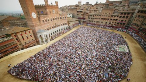Twice a year, riders from 10 of the city's 17 districts, known as "contrade", race three times around Siena's central square to win the Palio.