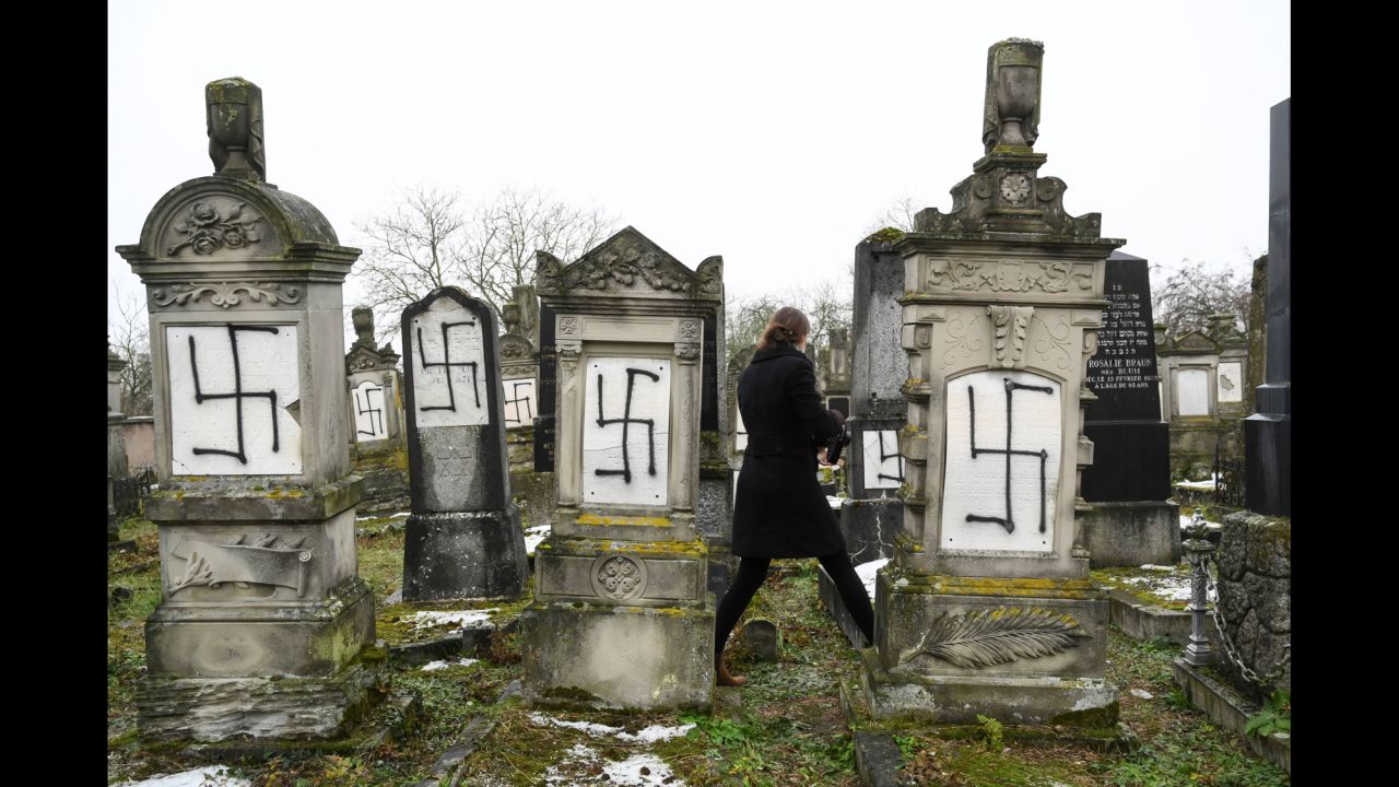 Jewish headstones are defaced with swastikas at a cemetery in Herrlisheim, France, on Monday, December 17. A Holocaust monument was also desecrated.