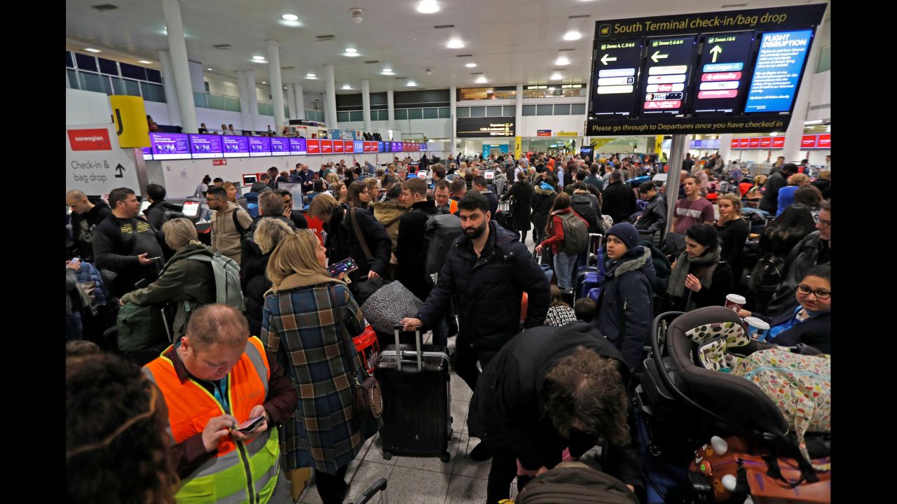 Air travelers wait in the South Terminal of London's Gatwick Airport on Thursday, December 20. Gatwick, the United Kingdom's second-biggest airport, <a href="https://www.cnn.com/2018/12/20/uk/gatwick-airport-drones-gbr-intl/index.html" target="_blank">was closed after drones were spotted near the airfield.</a> People due to fly on Thursday evening or Friday were being told not to go to the airport without first checking the status of the flight with the appropriate airline. Police were still on the hunt for the drone operators.
